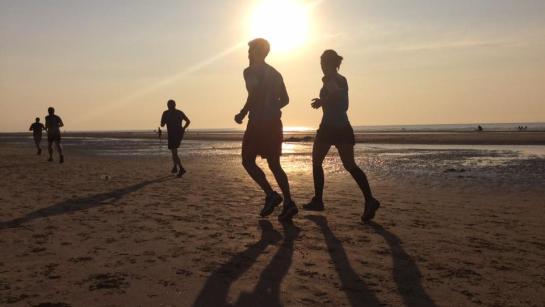 Loopwedstrijd met de ondergaande zon op de achtergrond